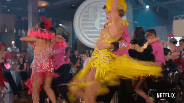 a group of people are dancing in front of a sign that says netflix on it