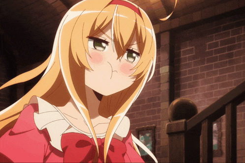a girl with blonde hair and green eyes is making a face