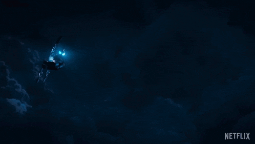 a man in a superhero costume is swimming in the dark with a netflix logo in the corner
