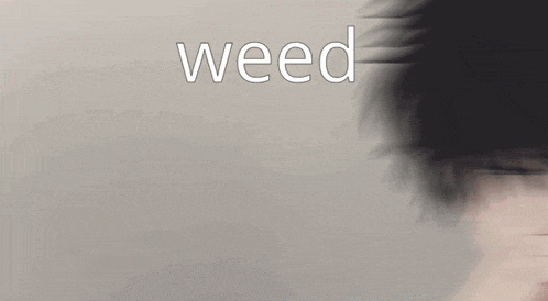 a blurry picture of a person with the word weed written above them