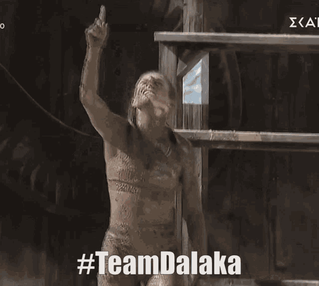 a naked woman with #teamdalaka written on her face
