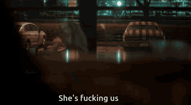 a man in a leather jacket says she 's fucking us in a dark room
