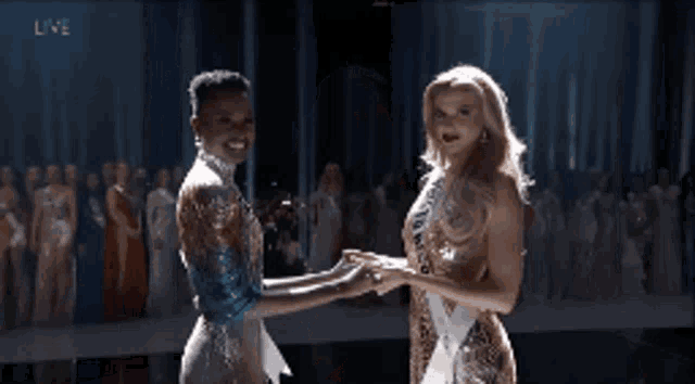 a woman wearing a sash that says florida on it is dancing with another woman