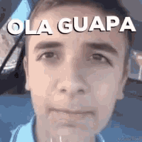 a close up of a man 's face with the words ola guapa written on his face .
