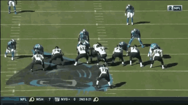 a football game is being played between the ny giants and the dolphins