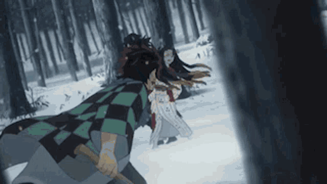 a man and a woman are fighting in a snowy forest .