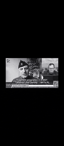 a black and white photo of a man in a military uniform talking to another man in front of a computer screen .