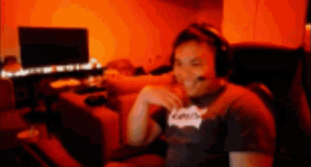 a man wearing headphones and a shirt that says levis is smiling