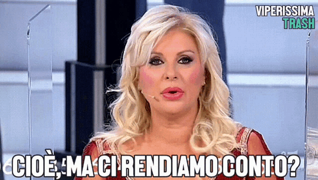 a blonde woman with a microphone in her mouth says " cioe ma ci rendiamo conto "