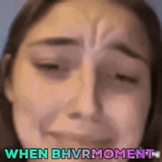 a close up of a woman 's face with the words when bhvrmoment written on it .