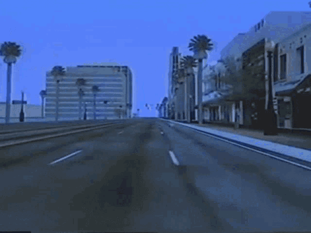 a city street with palm trees and a building that says twp