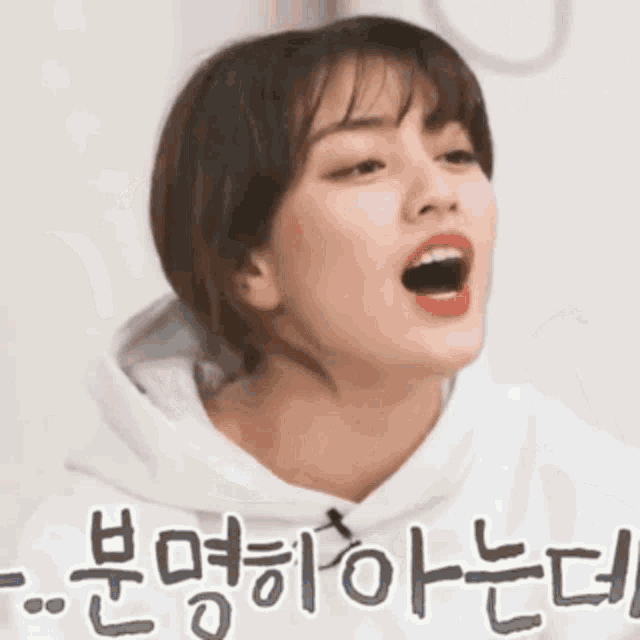 a woman is making a funny face with her mouth open .