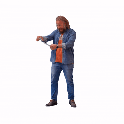 a man in a denim shirt and an orange shirt is holding a white object