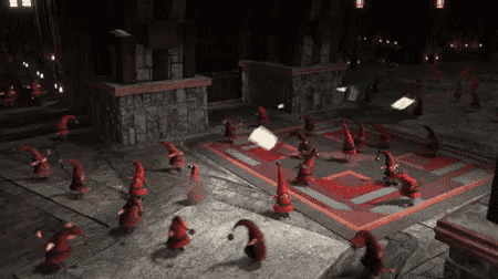 a group of gnomes are dancing in a room with a red rug .