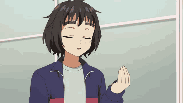 a girl in a blue jacket is smiling and waving her hand