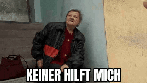 an elderly woman in a leather jacket is leaning against a wall and making a funny face .