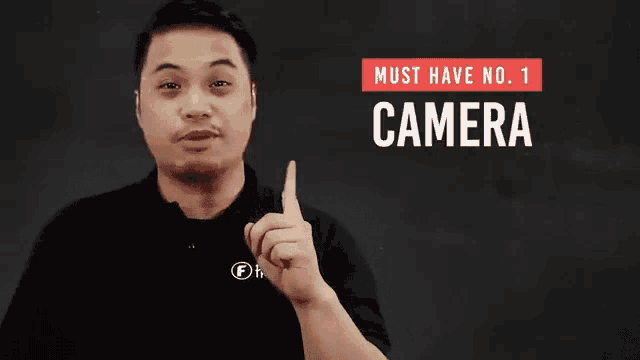 a man in a black shirt points to the camera