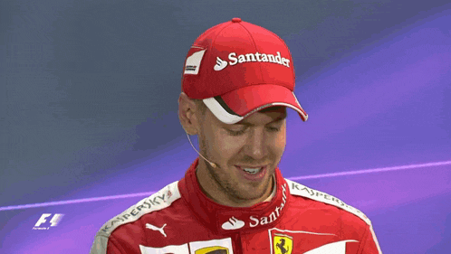 a man wearing a santander hat is holding a yellow flag