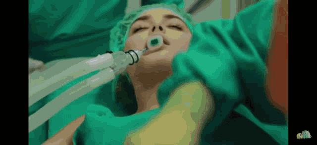 a woman in a surgical gown with an oxygen mask in her mouth