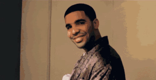 a man is smiling and looking at the camera while wearing a robe .