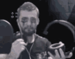 a man with a beard and face paint is holding a roll of tape .