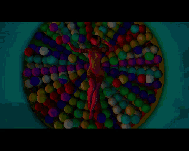 a woman in red is laying in a pool of colorful balloons