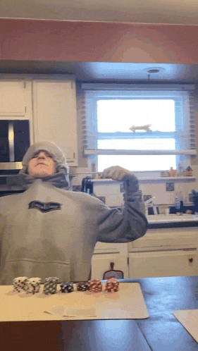 a person wearing a grey sweatshirt with the word eagles on the front