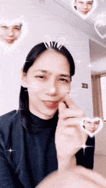 a woman with bunny ears on her head is making a heart with her hand