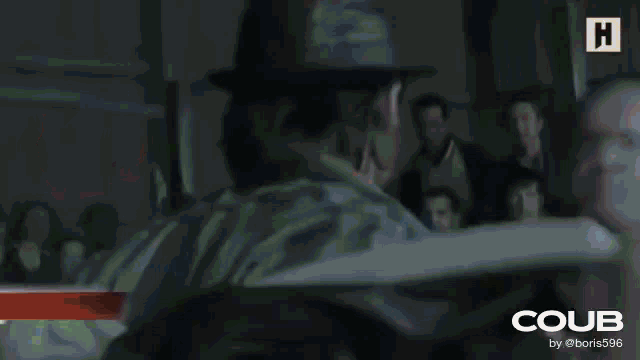 two men are standing next to each other in a room with the word coub on the bottom right