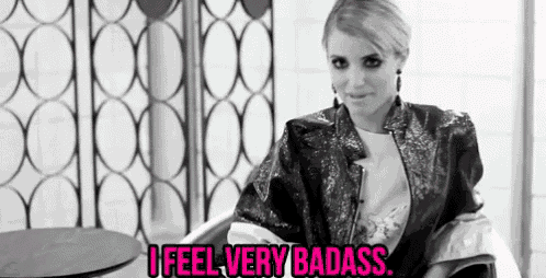 a black and white photo of a woman with the words i feel very badass written in pink .
