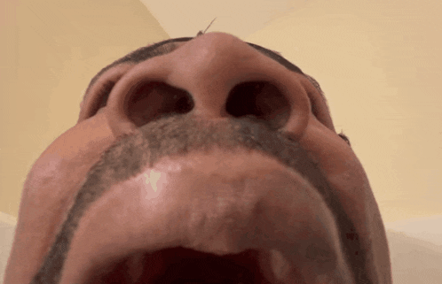 a close up of a man 's face with his mouth wide open