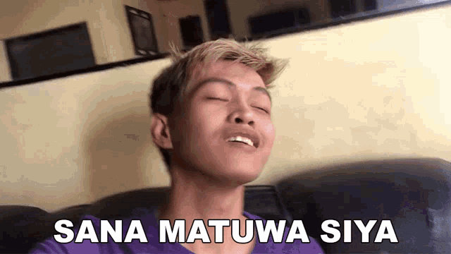 a man is sitting on a couch with his eyes closed and the words sana matuwa siya written on his face