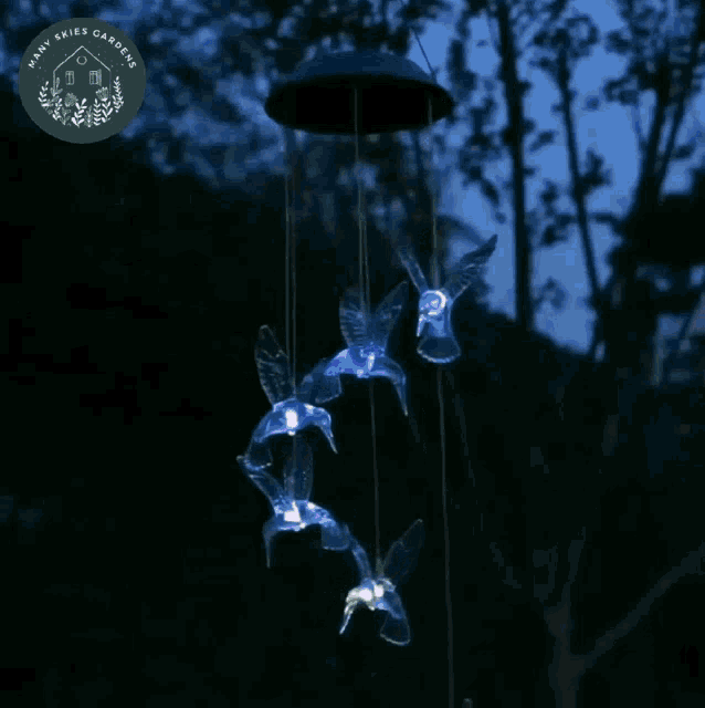 a wind chime made by dark skies gardens is hanging from a tree