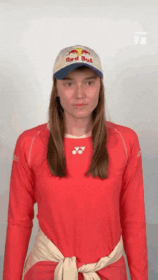 a woman wearing a red bull shirt and a red bull hat