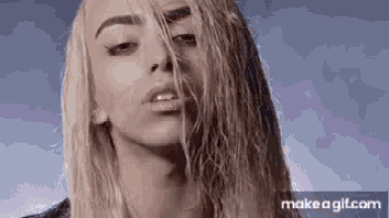 a close up of a woman 's face with wet hair and a scar on her face .