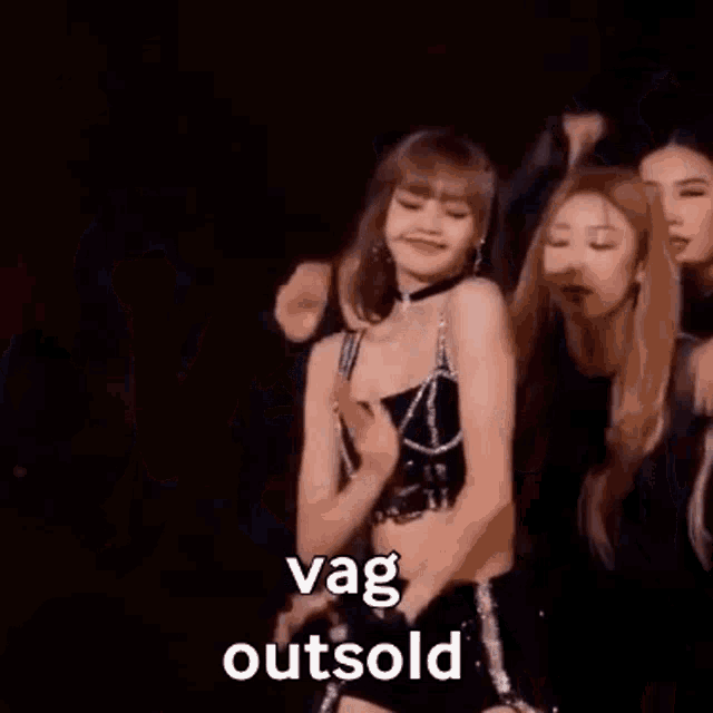 a group of women are standing next to each other on a stage and dancing .