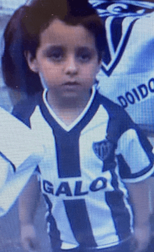 a young boy is wearing a jersey that says galo on the front