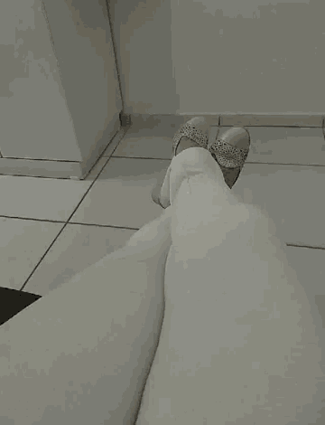 a person wearing white pants and shoes with rhinestones