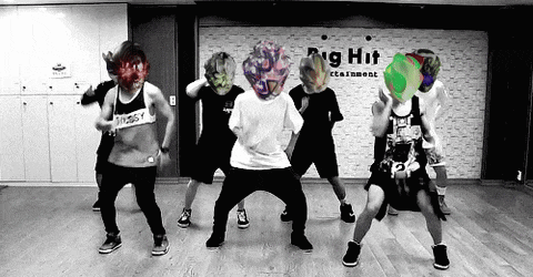a group of people are dancing in front of a sign that says big hit