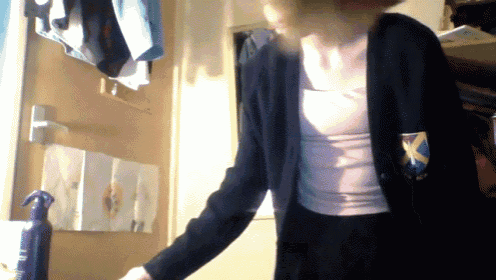 a woman in a school uniform with a badge that says x