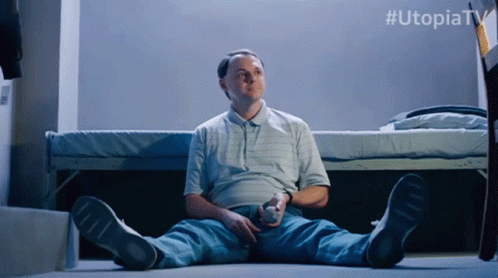 Sitting On The Floor Utopia GIF - Sitting On The Floor Utopia Throwing Ball In The Air GIFs
