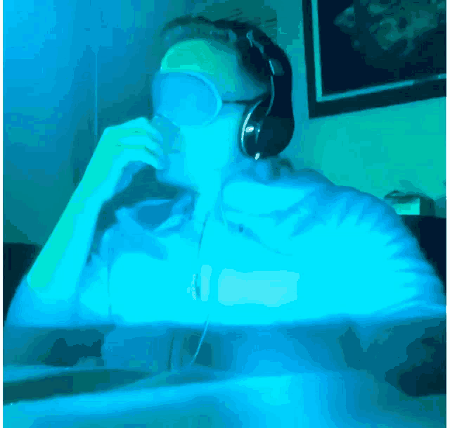 a man wearing headphones and blindfolds looks at something