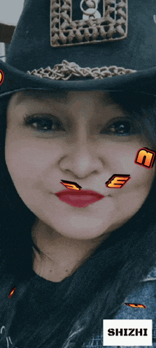 a woman wearing a cowboy hat has a sticker on her face that says " shizhi "