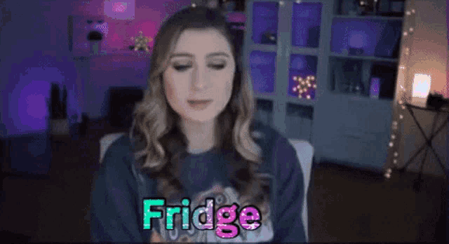 a woman is sitting in a chair with the word fridge written on her face