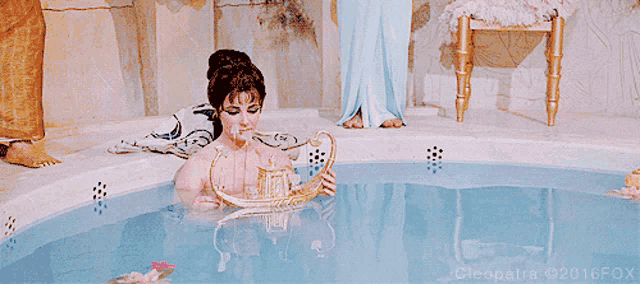 a woman in a bathtub with cleopatra 2016 fox written on the bottom right