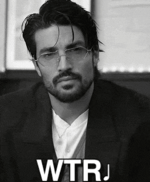 a black and white photo of a man with glasses and the word wtrj written below him
