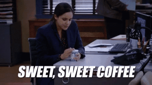 a woman is sitting at a desk with a cup of coffee and the words `` sweet , sweet coffee '' .