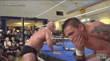 two men in a wrestling ring with a ggw logo on the bottom