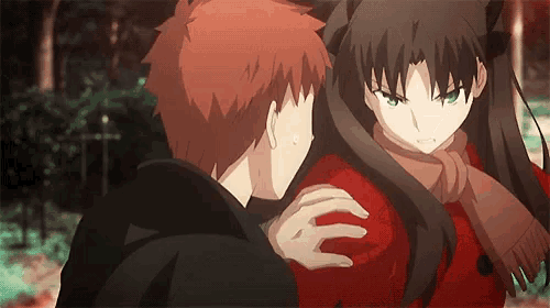 a boy and a girl are standing next to each other and the girl is wearing a red coat