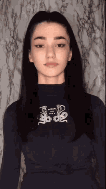 a woman wearing a black shirt with a snake design on it